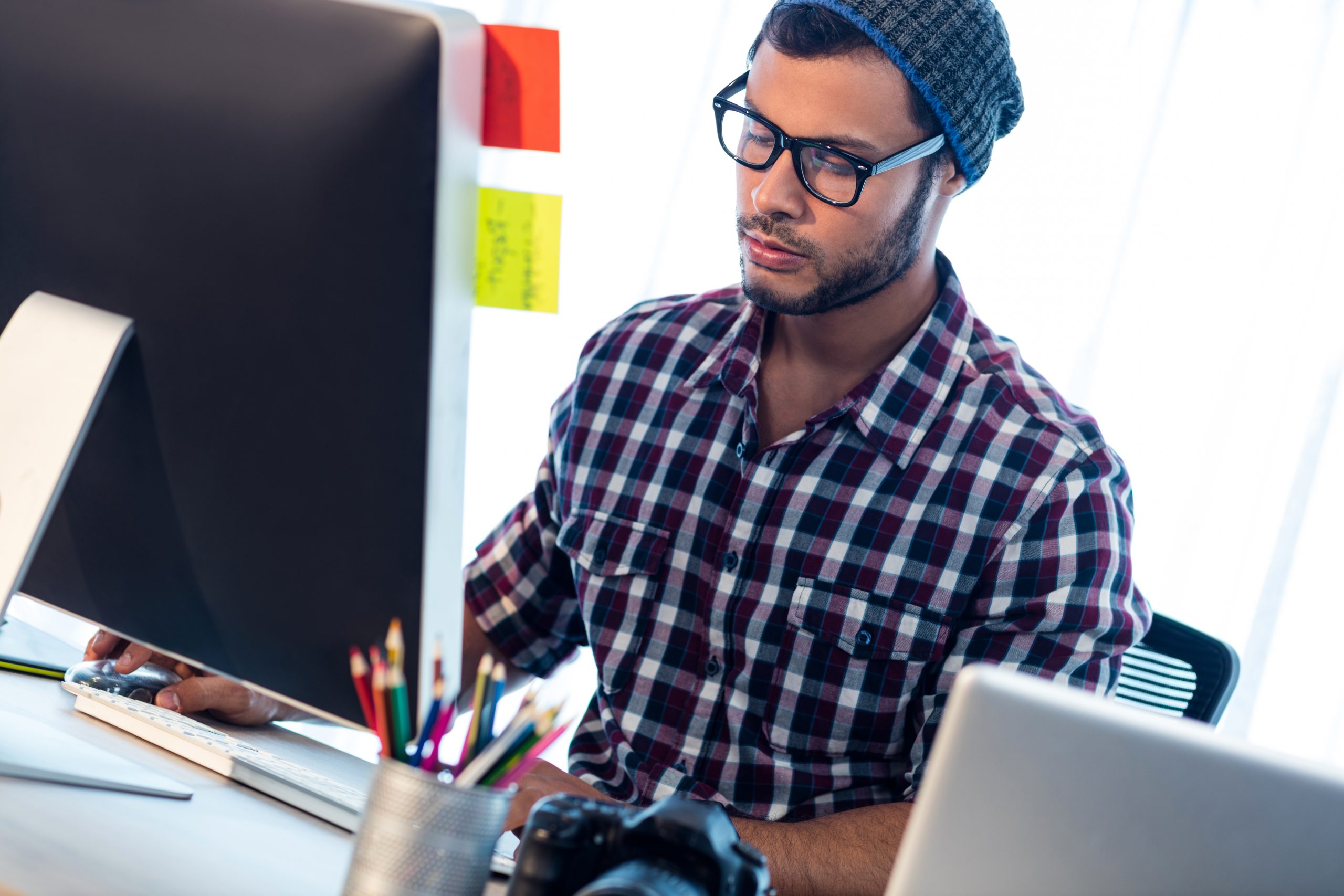 Photographer working at computer desk in studio